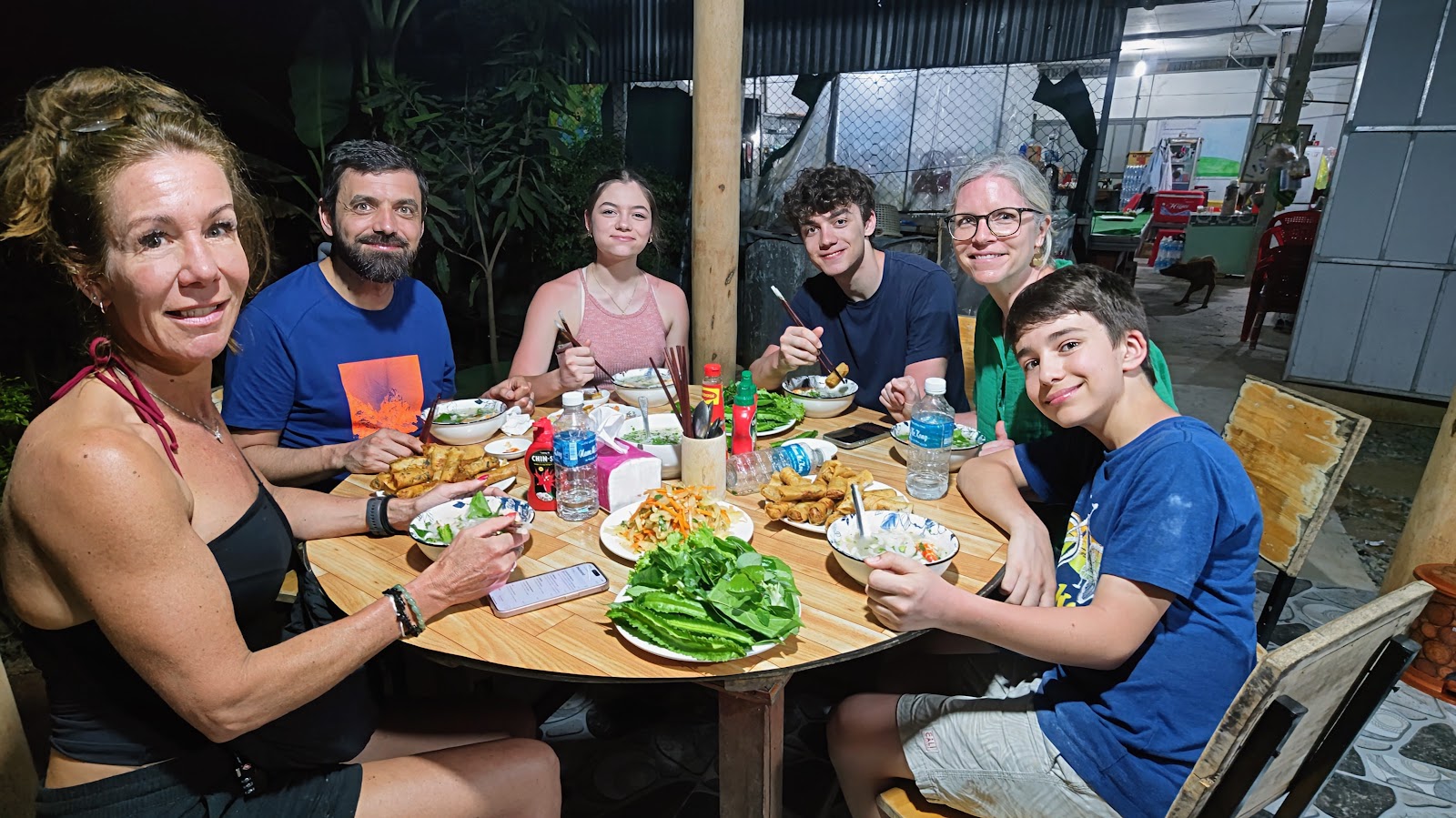 A family sharing a home-cooked dinner at Coco Happy Farm