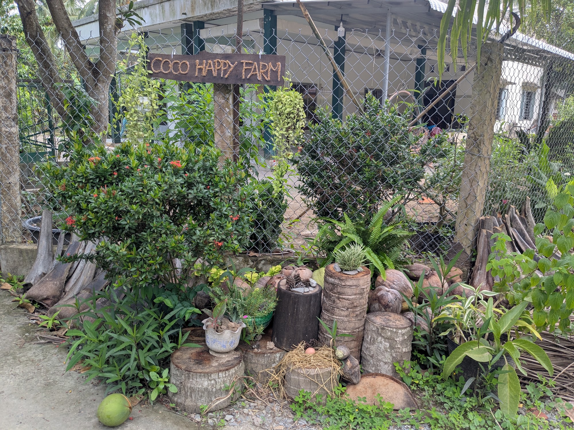 Rustic garden entrance sign at Coco Happy Farm in Luong Hoa, Ben Tre